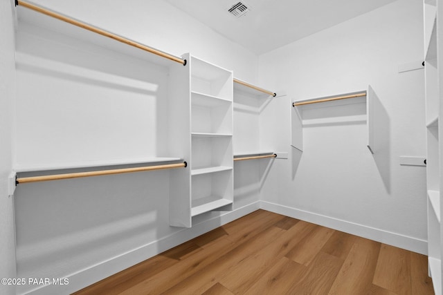 walk in closet featuring light hardwood / wood-style floors