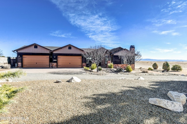 view of front of house featuring gravel driveway and a garage