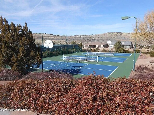 view of tennis court featuring basketball court