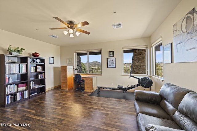 interior space with dark wood-type flooring and ceiling fan