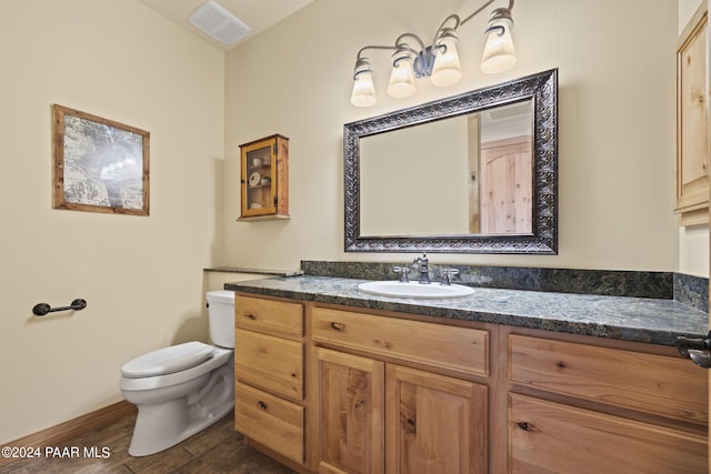 bathroom featuring vanity, toilet, and hardwood / wood-style floors