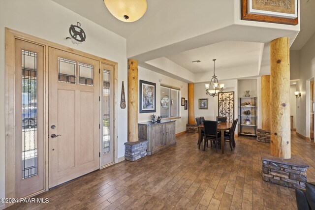 entrance foyer with a chandelier, dark hardwood / wood-style flooring, and a tray ceiling