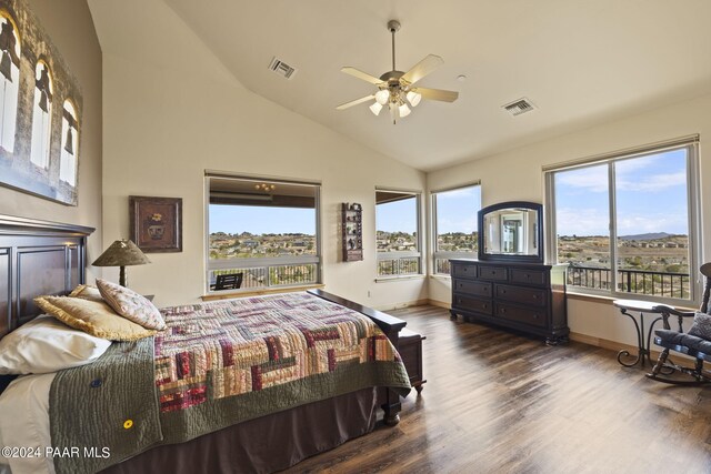 bedroom with dark wood-type flooring and high vaulted ceiling