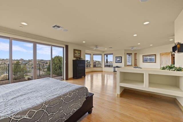 bedroom featuring access to exterior and light hardwood / wood-style flooring