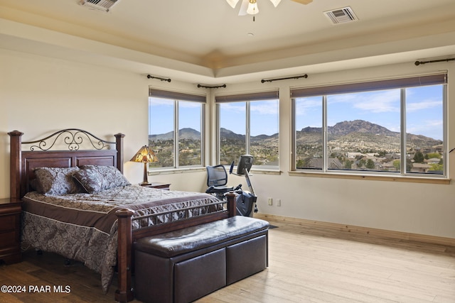 bedroom featuring a mountain view and light wood-type flooring