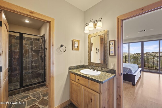 bathroom featuring a shower with door, vanity, and wood-type flooring