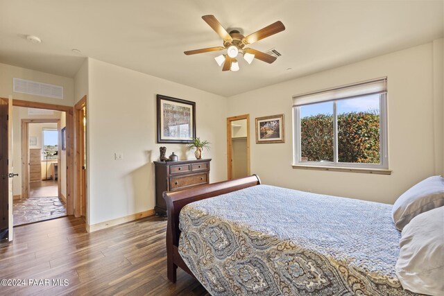 bedroom with ceiling fan and dark hardwood / wood-style flooring