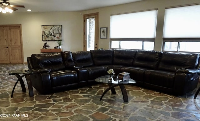 living room featuring ceiling fan and plenty of natural light