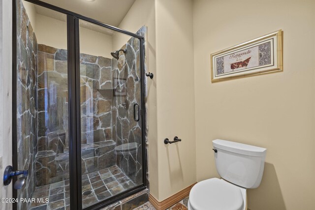 bathroom featuring walk in shower and toilet