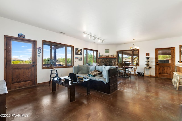 13225 N Bull Run Rd, Prescott, AZ 86305 - living room with finished concrete flooring, a chandelier, and track lighting