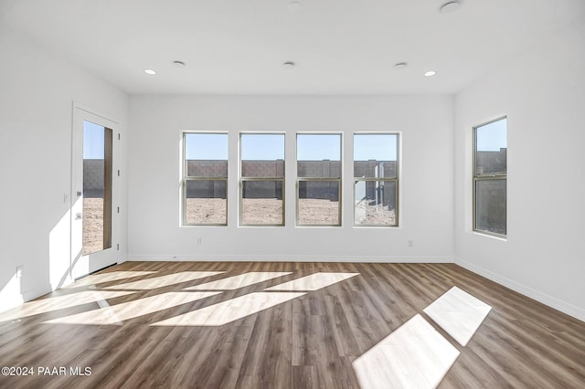 unfurnished room with hardwood / wood-style floors