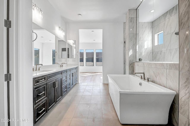 bathroom with tile patterned floors, vanity, and separate shower and tub