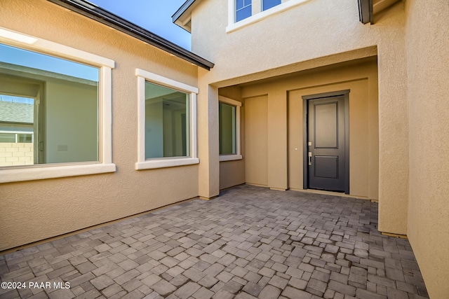 doorway to property with a patio