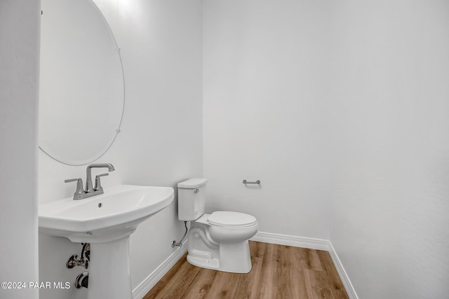 bathroom featuring hardwood / wood-style floors, toilet, and sink