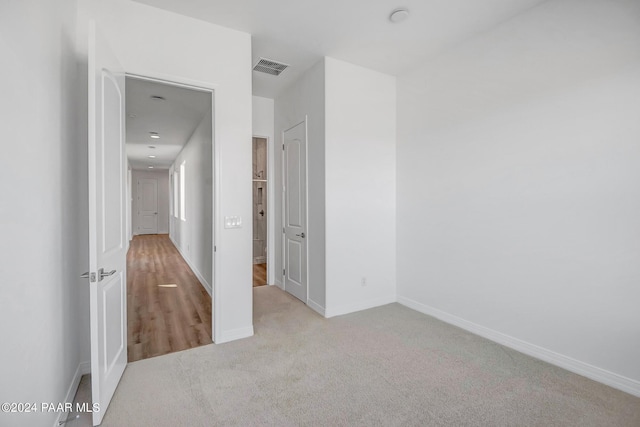 unfurnished bedroom featuring light colored carpet