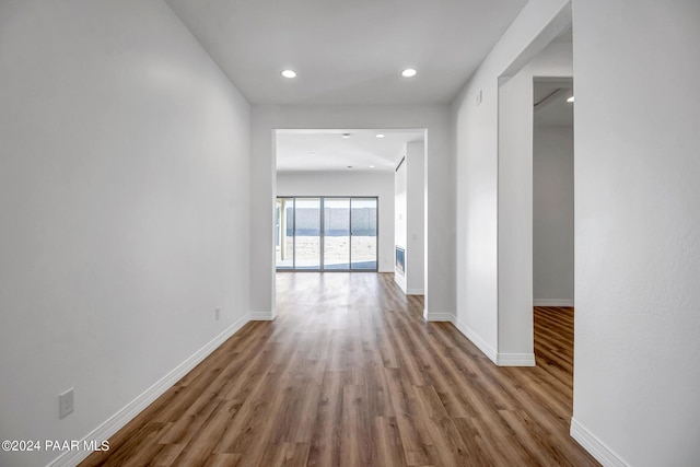 hallway with light hardwood / wood-style flooring