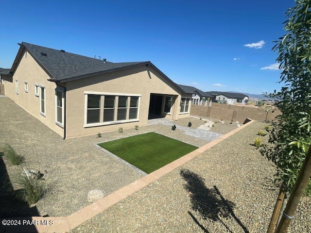 back of house featuring a yard and a patio