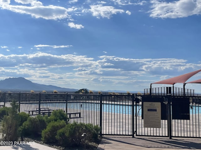 view of pool with a view of the beach and a water and mountain view