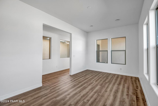 unfurnished room featuring hardwood / wood-style flooring