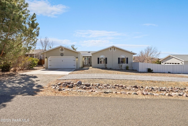 single story home with an attached garage, driveway, and fence