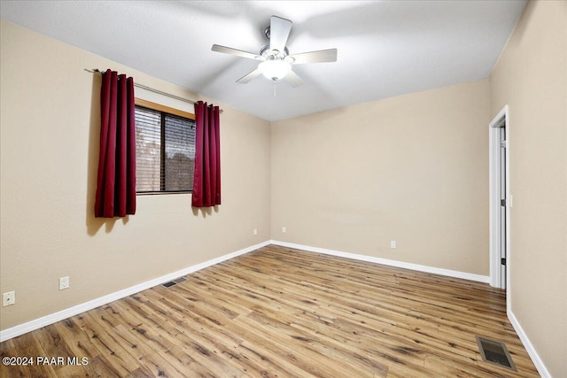 empty room featuring ceiling fan and light hardwood / wood-style flooring