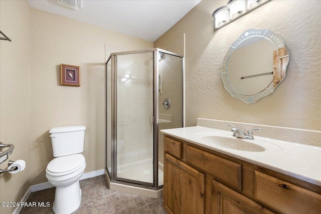 bathroom featuring vanity, an enclosed shower, tile patterned floors, and toilet