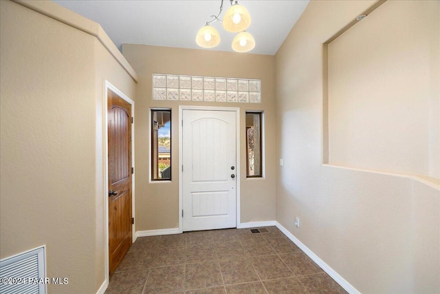 interior space featuring tile patterned flooring and a notable chandelier