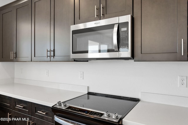 kitchen featuring range and dark brown cabinets