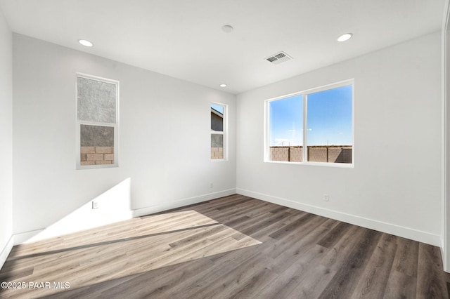 empty room with hardwood / wood-style flooring