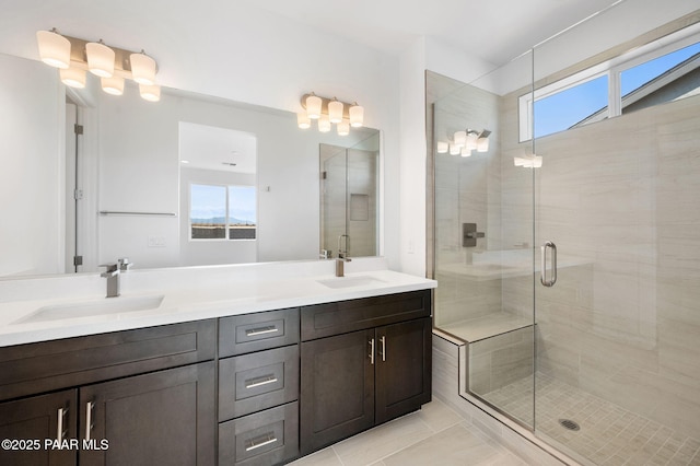 bathroom featuring tile patterned floors, a wealth of natural light, a shower with door, and vanity