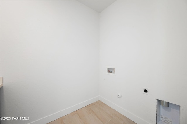 washroom featuring hardwood / wood-style flooring, gas dryer hookup, washer hookup, and hookup for an electric dryer