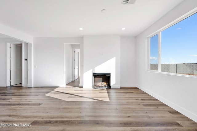 unfurnished living room with light hardwood / wood-style flooring