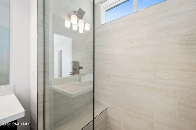 bathroom featuring vanity and tiled shower