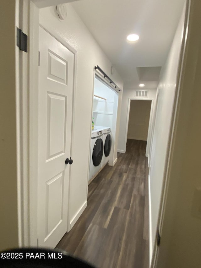 washroom featuring washer and dryer, recessed lighting, baseboards, visible vents, and dark wood-style floors