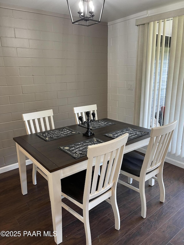 dining room featuring dark wood finished floors and a notable chandelier