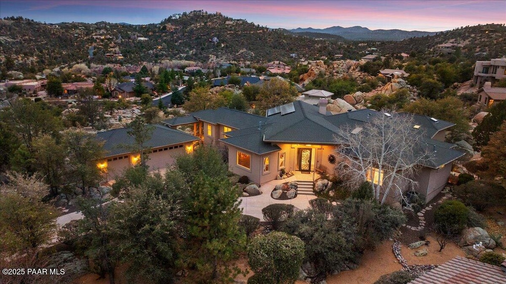 aerial view at dusk featuring a mountain view