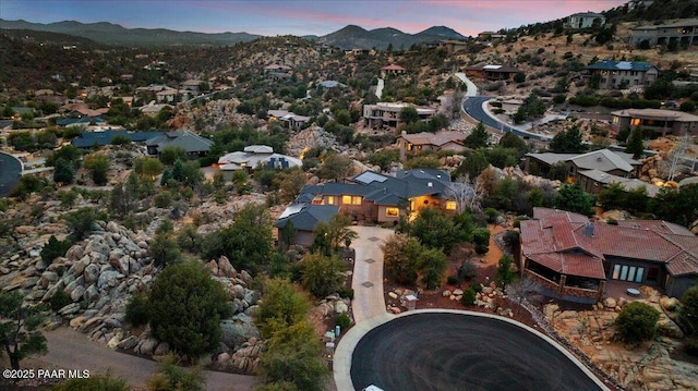 aerial view at dusk featuring a mountain view