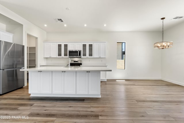 kitchen featuring visible vents, light countertops, and stainless steel appliances