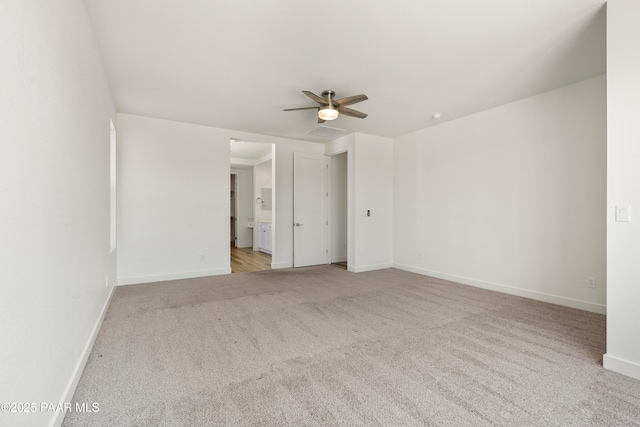 unfurnished room featuring a ceiling fan, baseboards, visible vents, and carpet