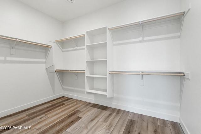 spacious closet featuring wood finished floors