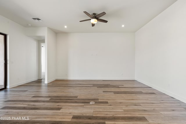 empty room featuring visible vents, recessed lighting, ceiling fan, and wood finished floors