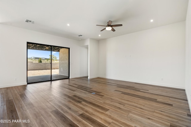 empty room featuring visible vents, wood finished floors, baseboards, ceiling fan, and recessed lighting