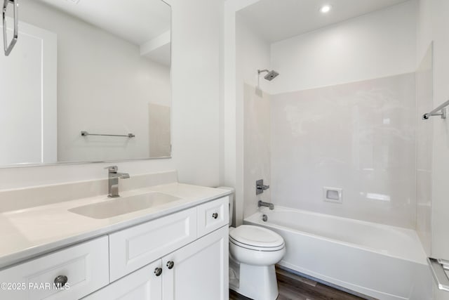 bathroom featuring vanity, toilet, recessed lighting, tub / shower combination, and wood finished floors