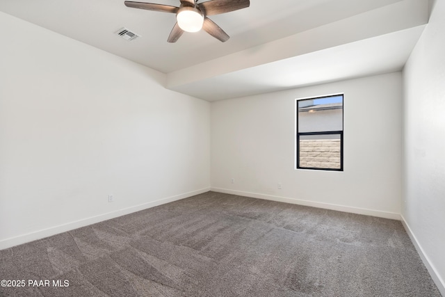 spare room with ceiling fan, visible vents, baseboards, and carpet