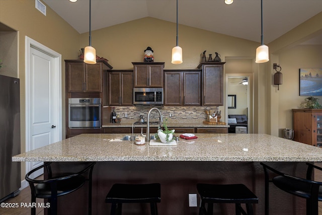 5245 Wellness Way, Prescott, AZ 86301 - kitchen featuring stainless steel appliances, tasteful backsplash, vaulted ceiling, dark brown cabinetry, and a sink