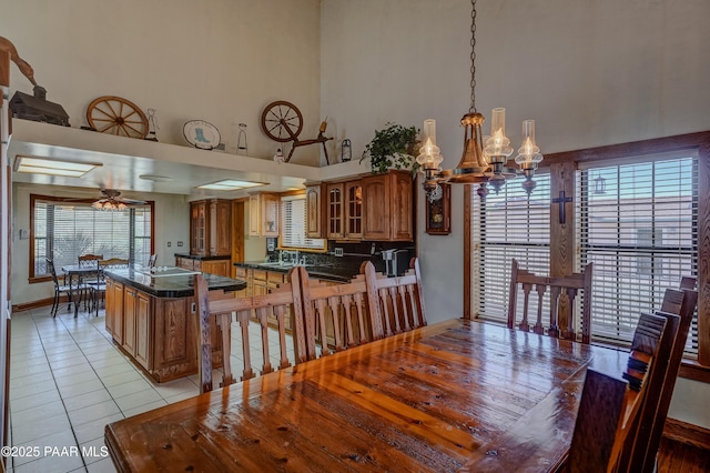 10412 E Prescott Dells Ranch Rd, Dewey-Humboldt, AZ 86327 - dining space featuring light tile patterned flooring, a high ceiling, a chandelier, and ceiling fan