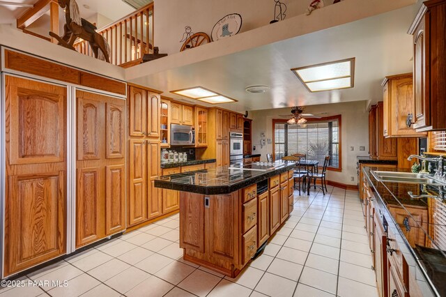10412 E Prescott Dells Ranch Rd, Dewey-Humboldt, AZ 86327 - kitchen with appliances with stainless steel finishes, a kitchen island, tile countertops, light tile patterned floors, and tasteful backsplash