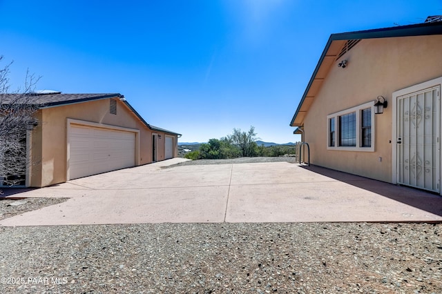 10412 E Prescott Dells Ranch Rd, Dewey-Humboldt, AZ 86327 - view of property exterior with stucco siding, a garage, and driveway