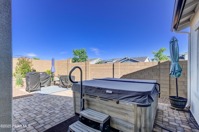 7028 Corral Ct, Prescott, AZ 86305 - fenced backyard featuring a hot tub, a grill, and a patio