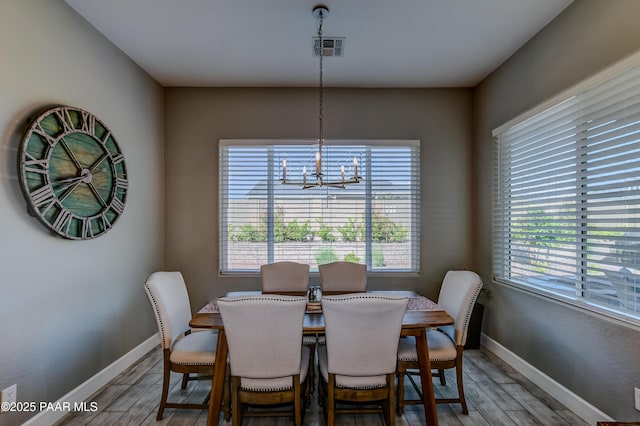 7028 Corral Ct, Prescott, AZ 86305 - dining area featuring healthy amount of natural light, wood finished floors, and a chandelier